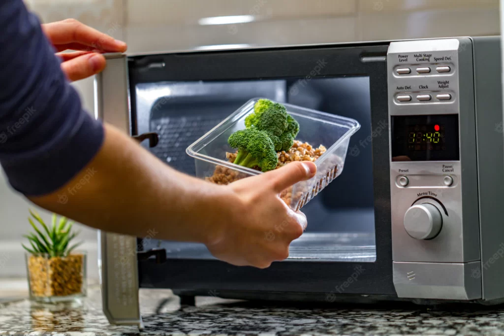 woman s hand puts plastic container with broccoli buckwheat microwave 122732 1179
